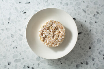A top down view of a rice cake on a plate.