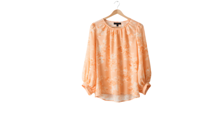 Elegant orange blouse with floral patterns hanging on a hanger, set against a minimalistic background, ideal for fashion displays