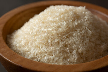 A closeup view of a bowl of agar agar flakes.