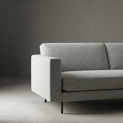 Modern gray sofa with clean lines in a minimalist setting. Stylish and comfortable living room furniture detail.