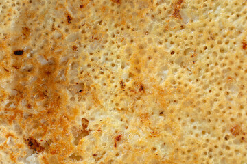 A top down view of a rava masala dosa, as a background.