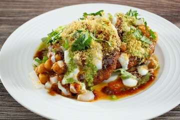 A closeup view of a plate of aloo tikki chaat.