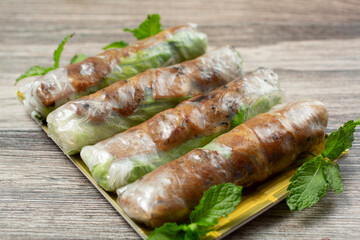 A view of a plate of BBQ pork spring rolls.
