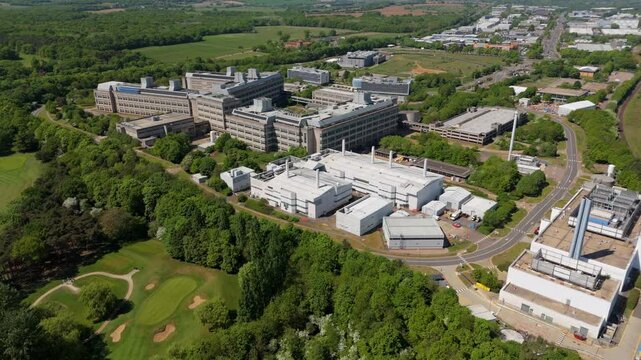 Aerial drone industrial area buildings GSK Stevenage sunny Spring day UK England factory manufacturing pharmaceuticals 