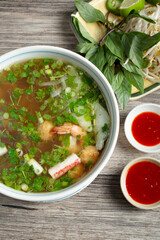 A top down view of a bowl of seafood pho.