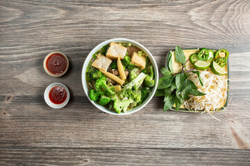 A top down view of a bowl of veggie pho.