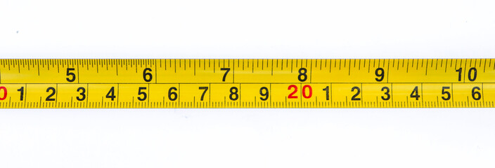 Closeup Yellow Measuring Tape Shows Centimeters and Inches Numbers on White Surface