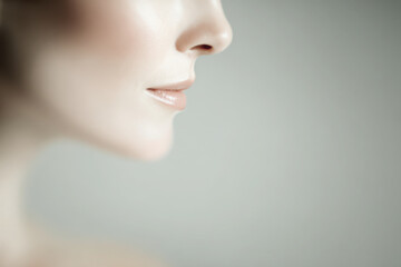 Fototapeta premium minimalistic portrait of woman emphasizing her face soft and gentle lighting clean and simple composition airy