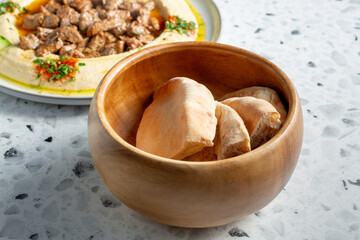 A view of pita bread and hummus.