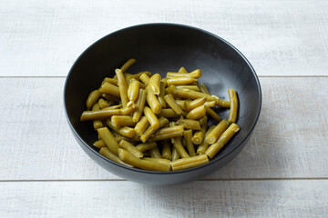 A view of a bowl of canned green beans.