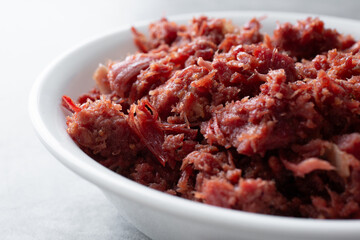 A closeup view of a bowl of cooked canned corned beef.