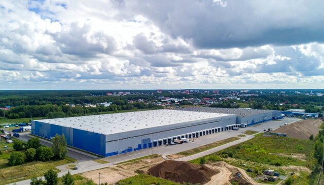 Aerial View of Modern Warehouse Building Surrounded by Nature