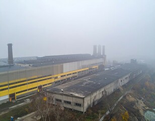 Fototapeta premium Industrial Complex amidst Thick Fog in Urban Environment