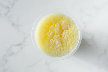 A top down view of a mango slushie drink.