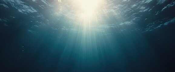Fototapeta premium Underwater scene with sunlight streaming from the surface down through the water