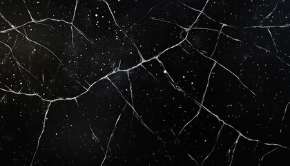 Cracked black surface with white lines and specks