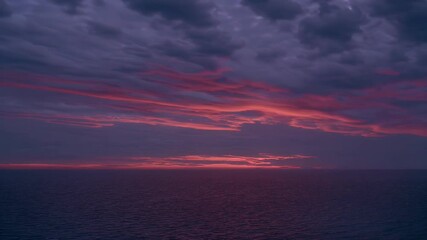 Breathtaking b roll footage vibrant sunset clouds glowing dark ocean waters capturing twilight transition atmospheric calm 4K slow motion