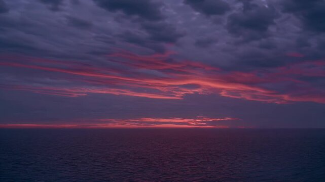 Breathtaking b roll footage vibrant sunset clouds glowing dark ocean waters capturing twilight transition atmospheric calm 4K slow motion