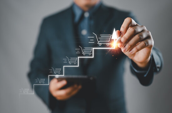 E-commerce growth and online sales strategy development. Businessman pointing to arrow with shopping cart icons, digital marketing success, online sales growth, performance optimization for business