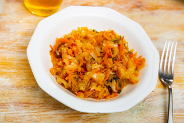 Fresh portion of braised cabbage served on plate. Stewed vegetables.
