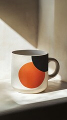 Modern ceramic cup with artistic design on a sunlit surface