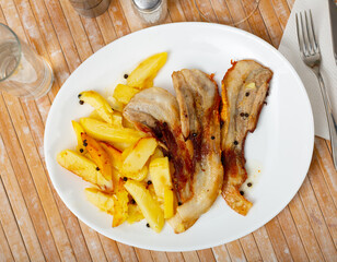 Image of fried pork bacon on a plate and French fries...