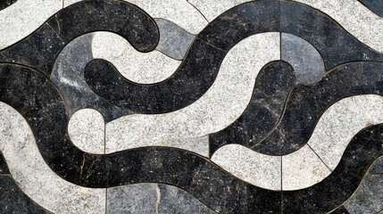 Intricate, abstract stone pattern on a paved surface.