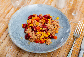 Vibrant traditional Mexican tuna salad with red kidney beans, corn, and diced fresh vegetables, offering healthy and flavorful meal