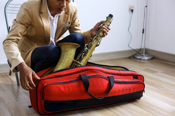 Musician Male Taking Saxophone Out Of Its Case