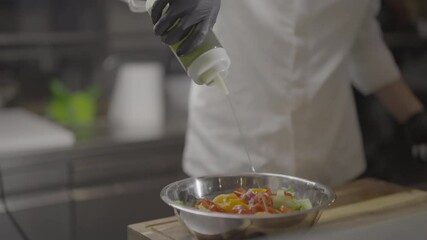 Professional Chef Prepares Fresh Salad in a Modern Kitchen