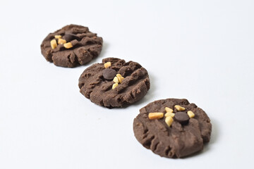 Close up view of three cookies with peanut and chocolate chips. Freshly Baked Homemade. perfect for bakery advertisements and dessert menus. Clipping path. Isolated on white background