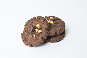 Close up view of three cookies with peanut and chocolate chips. Freshly Baked Homemade. perfect for bakery advertisements and dessert menus. Clipping path. Stack. Pile. Isolated on white background.