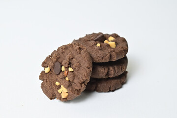 Close up view of four cookies with peanut and chocolate chips. Freshly Baked Homemade. perfect for bakery advertisements and dessert menus. Clipping path. Stack. Pile. Isolated on white background.