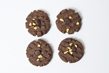 Close up view of four cookies with peanut and chocolate chips. Freshly Baked Homemade. perfect for bakery advertisements and dessert menus. Clipping path. Isolated on white background.