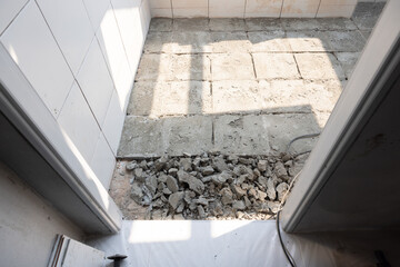 Break for scrape or crushed concrete by demolish remove tile and concrete floor inside toilet bathroom by jacking hammer for re-construction or installation tile floor again cause of quality control. 