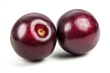 Obraz premium Two ripe dark plums, glossy, round, and close together
