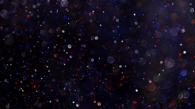 Blurry sparkling red white and blue glitter for a bokeh of lights with dynamic motion. Abstract background for USA 4th of July, Memorial Day, Veteran's Day, or other patriotic US American holidays.