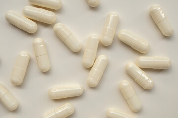 White medicine pills capsule on white background
