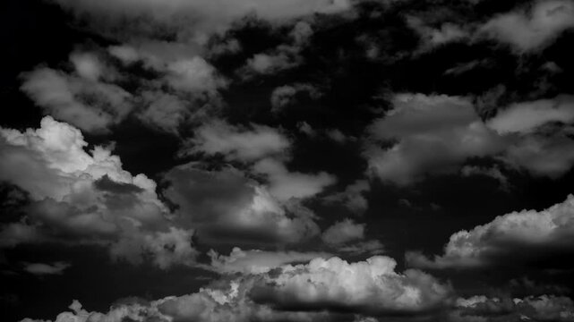 time-lapse of separate white clouds on a black background have real clouds