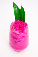 vibrant pink smoothie served in transparent glass with green tropical leaf garnish on white background dragon fruit. High quality photo