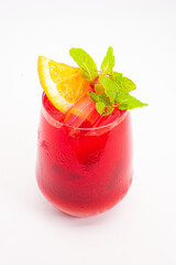 vibrant red berry cocktail with orange slice and fresh mint leaves served in clear glass with ice...
