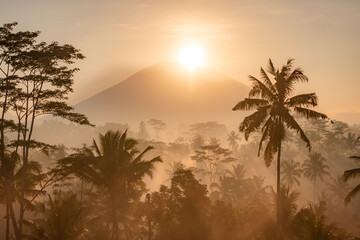 The sun rises over Mount Agung which is a photo from Gianyar