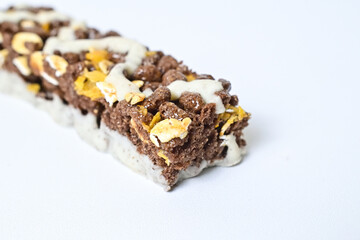 Close up view of Healthy Snack, Cereal Bar, Multigrain Bar with coffee extract isolated on white background. Tiramisu delight. Clipping path. Half view.