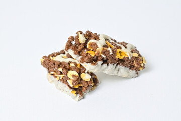 Close up view of Healthy Snack, Cereal Bar, Multigrain Bar with coffee extract isolated on white background. Tiramisu delight. Clipping path. Stack, pile. Broken.