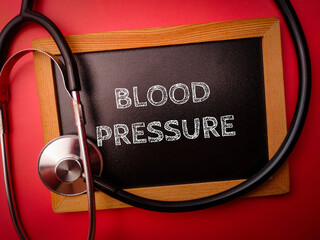 Statehoscope and wooden board with the word BLOOD PRESSURE on a red backgorund