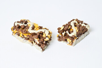 Close up view of Healthy Snack, Cereal Bar, Multigrain Bar with coffee extract isolated on white background. Tiramisu delight. Clipping path. Broken. 