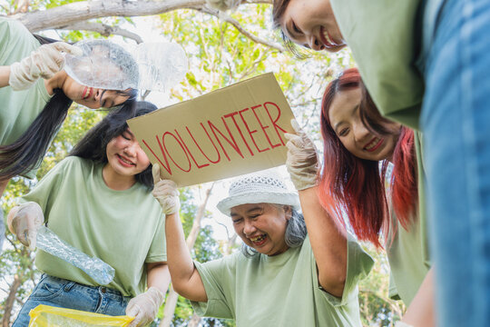 Happy Group of People Volunteering for Environmental Cleanup, Diverse Volunteers Cleaning Up Park Together, Community Team Collecting Plastic Waste in Nature - Powered by Adobe