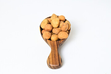Photo of egg nuts in the little wooden spoon isolated on white background. Clipping path. Close up. 