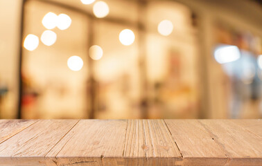 Empty wood table top and blur of restaurant background selective focus product display