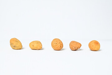 Side view of five egg nuts isolated on white background. Clipping path. Close up. 
